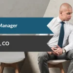 Banner showing 'Practice Manager' with a magnifier icon and 'Lone Tree, CO' on blue and dark ribbons; two professionals sit discussing with a laptop nearby.
